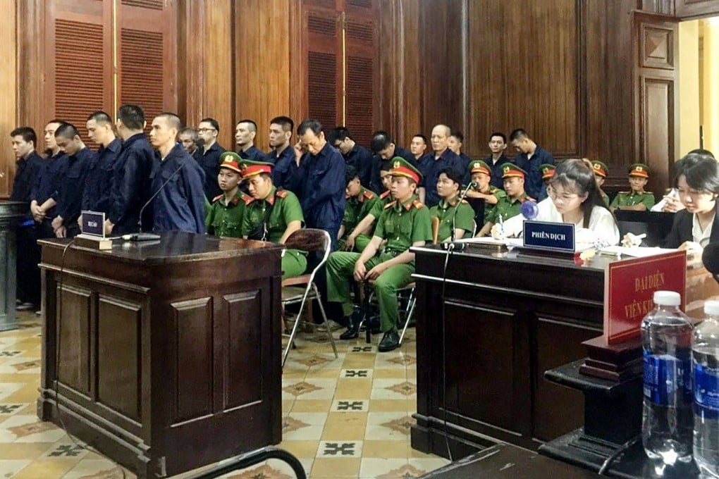 Defendants (in blue) stand during their trial for drug trafficking in Ho Chi Minh on November 12, 2023. Photo: Vietnam News Agency/AFP