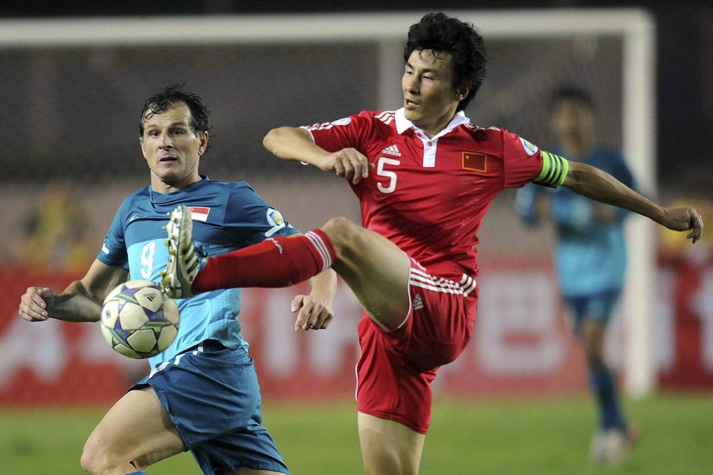 Li Weifeng (right) played for his country for 11 years and was a member of the only squad to reach a World Cup. Photo: AP