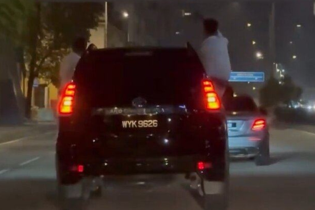 Men hang out a car and sit on the windows in Kuala Lumpur early Friday morning. Photo: Reddit/whusler