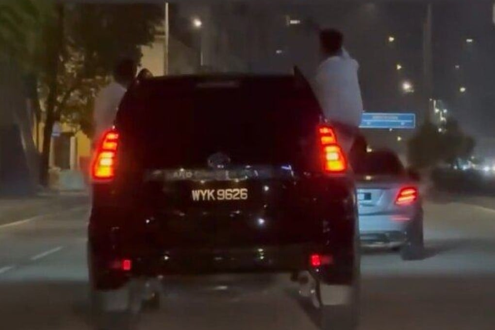 Men hang out a car and sit on the windows in Kuala Lumpur early Friday morning. Photo: Reddit/whusler