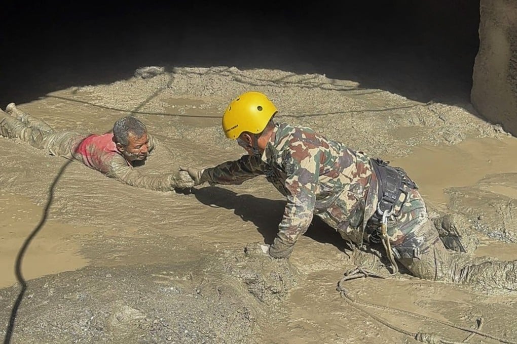 Nepal Army personnel rescue a survivor from a hydropower tunnel on Friday, following flash floods in Rasuwa District. Photo: Nepal Army via EPA