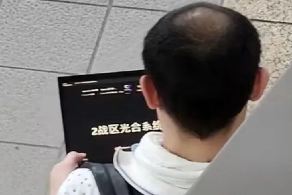 The controversy erupted after a social media user photographed a man holding a laptop on a Taipei Main Station metro platform on Saturday, with the screen displaying the words “2nd Theatre Photosynthesis System” in simplified Chinese. Photo: Handout