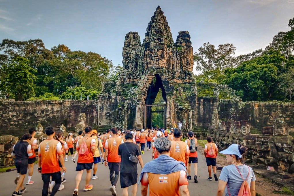 Competitors tackling the 10km race make their way through the South Gate of Angkor Thom, in Siem Reap, Cambodia. Photo: Marissa Carruthers