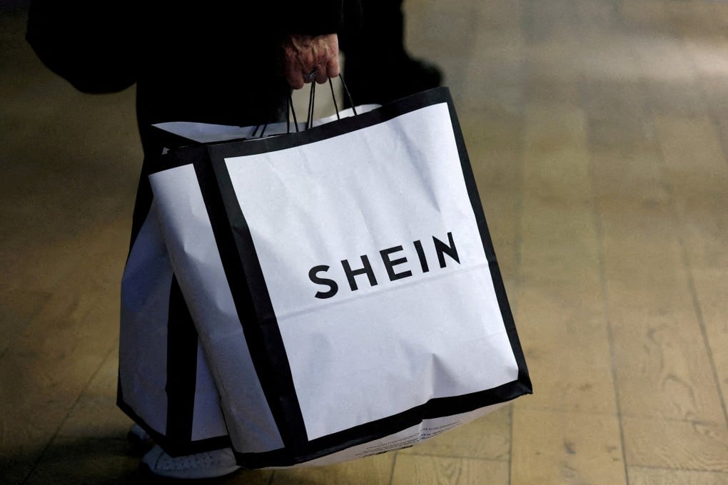 A customer holds shopping bags with the Shein logo. Photo: Reuters