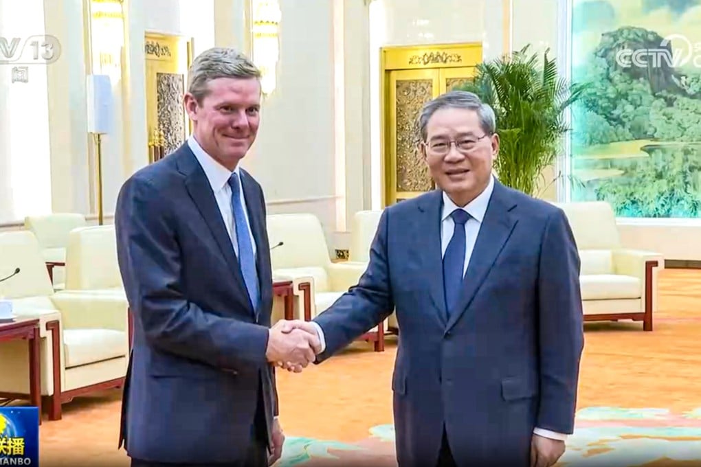 Chinese Premier Li Qiang, right, shakes hands with Visa CEO Ryan McInerney during a meeting at the Great Hall of the People in Beijing on Tuesday. Photo: CCTV