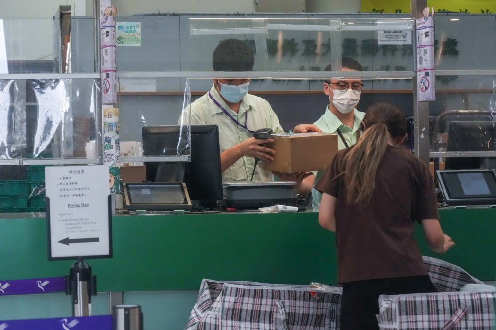 Staff members help a customer at the General Post Office in Central on August 18. Some 200 employees still on probation will be affected by the decision to end offers of permanent civil service positions at Hongkong Post. Photo: Jelly Tse