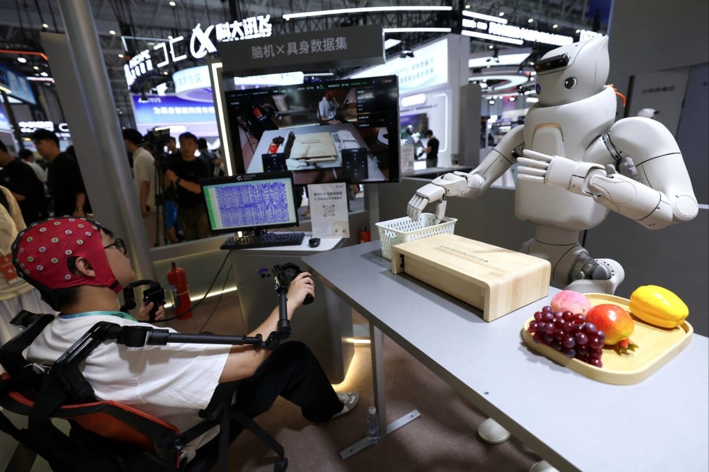 An engineer wears a brain-computer interface head cap to pilot a humanoid robot at the Fourier Intelligence booth during last month’s World Robot Conference in Beijing. Photo: Reuters