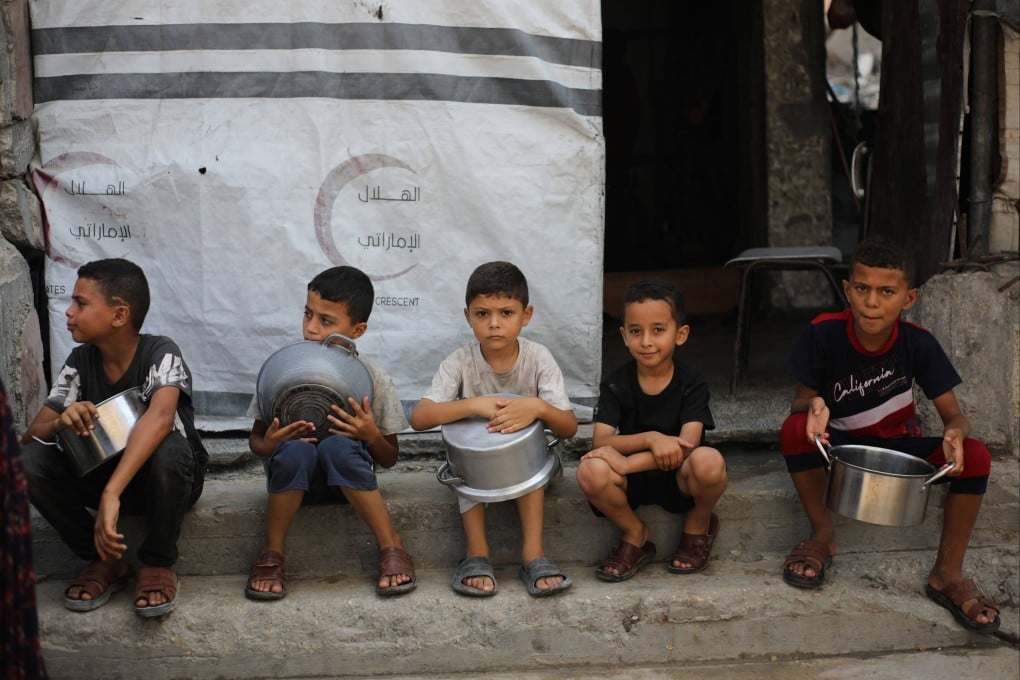 Displaced Palestinian children gather to receive food from a charity kitchen in the northern Gaza Strip on Saturday. Photo: APA Images/ZUMA Press Wire/dpa