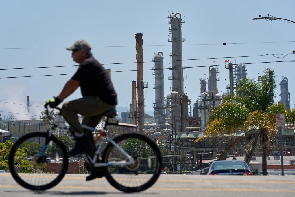 A cyclist rides past the Chevron Products Company refinery, one of California’s largest petroleum processing facilities, in El Segundo, in April. Photo: AP