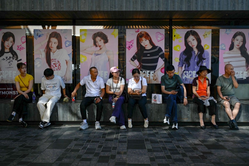 People rest outside a store in Beijing on August 31. Photo: AFP