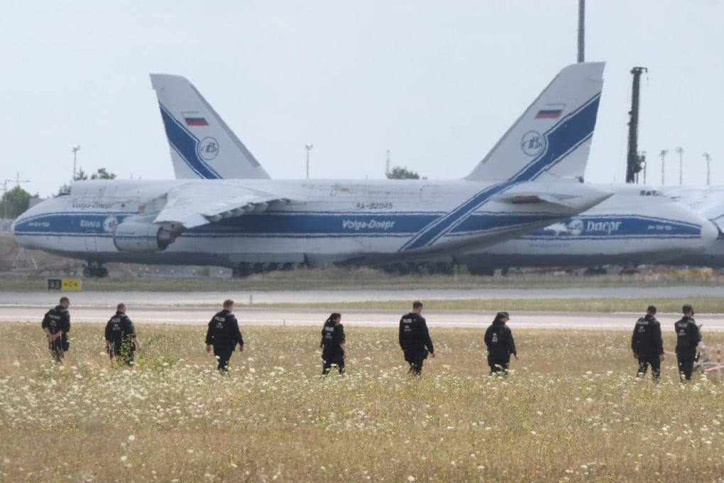 Police officers search a field on the grounds of Leipzig/Halle Airport in Germany in August after an attempted drone attack. Photo: dpa via AP