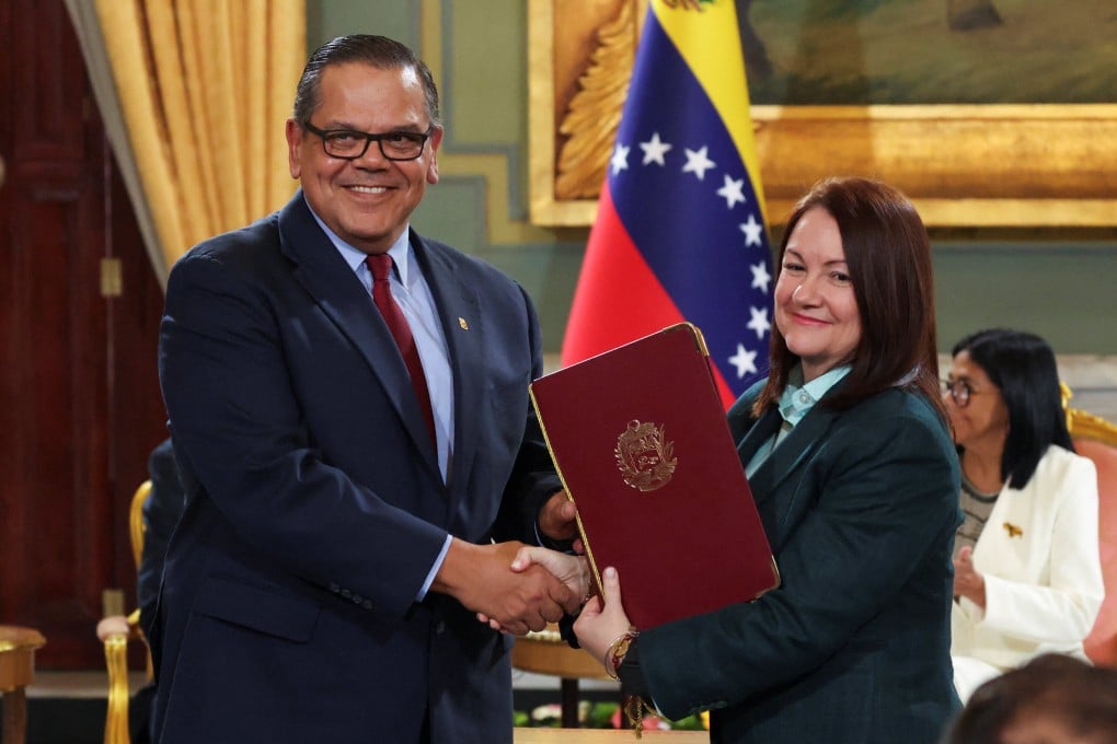 Chevron Venezuela President Mariano Vela shakes hands with Venezuela’s Oil Minister Paula Henao as they attend the signing of an agreement between US oil major Chevron and government officials to expand the company’s operations at Miraflores Palace in Caracas on Wednesday. Photo: Reuters