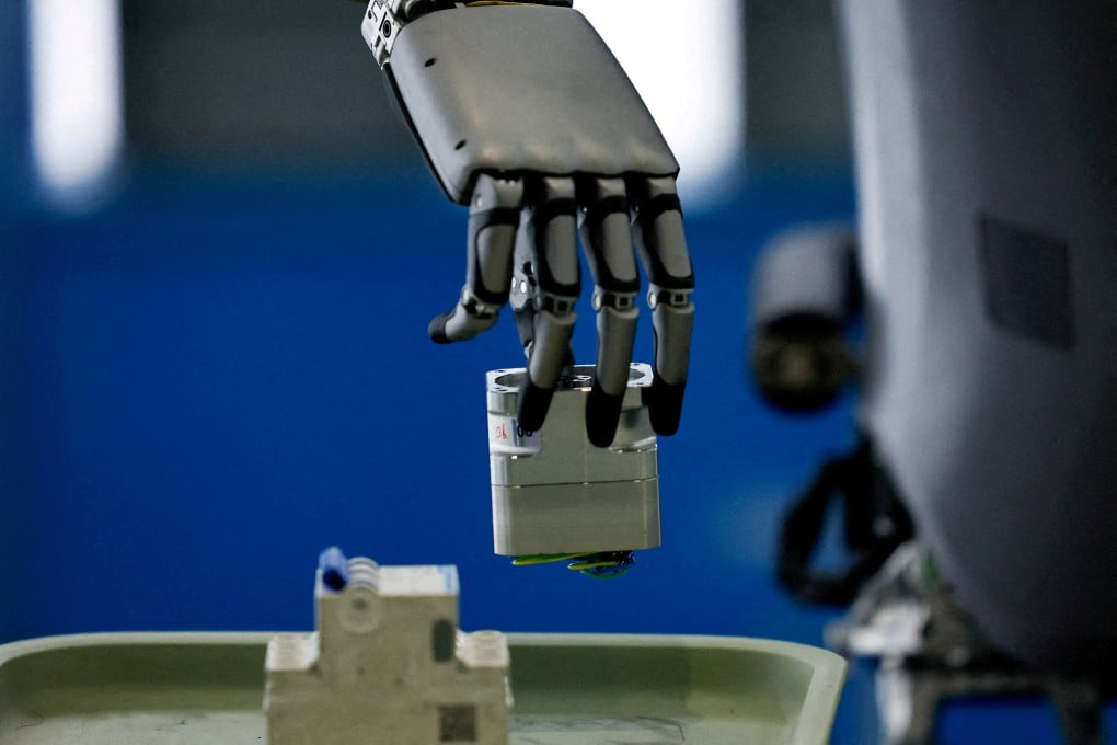 A UBTech humanoid robot picks up an object during a demonstration simulating a factory’s assembly line, in the Beijing Robotics Industrial Park in Beijing E-Town in 2025. Photo: Reuters