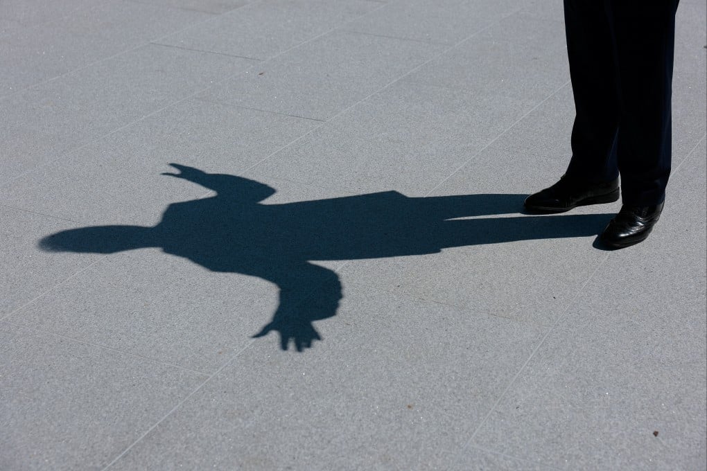US President Donald Trump’s shadow is seen as he speaks to reporters at the White House in August. Photo: Reuters