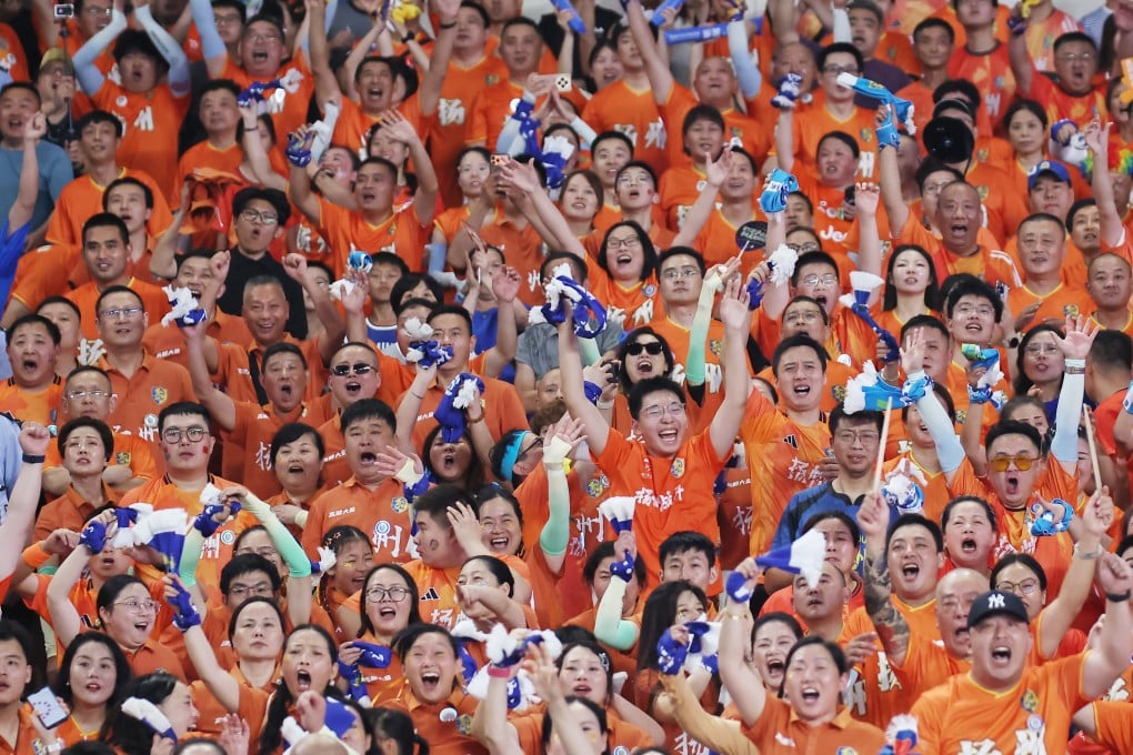 Fans of Team Yangzhou celebrate a goal during a football match against Team Nanjing on August 15. Photo: China News Service via Getty Images