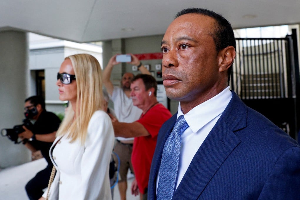 Tiger Woods leaving the courthouse with his girlfriend, Vanessa Trump, after his appearance before a judge on Wednesday. Photo: Reuters