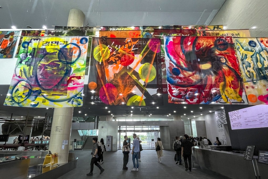 The lobby of the Busan Museum of Contemporary Art features a selection of images taken from The House of Korean Protest Songs archive during the 2026 Busan Biennale. Photo: Enid Tsui