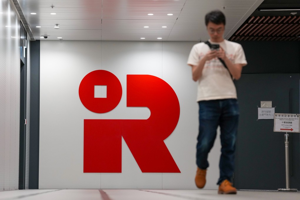 People walk past the Inland Revenue Centre’s logo in Kai Tak on May 4. Photo: Karma Lo