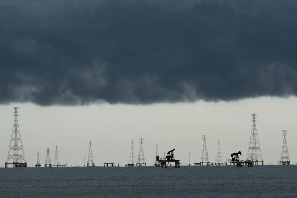 Clouds form over pumpjacks and power transmission towers on Lake Maracaibo, one of the world’s richest petroleum-producing regions, in Cabimas, Venezuela, on September 1. The US has secured effective control over 65 billion barrels of Venezuelan oil reserves. Photo: AP