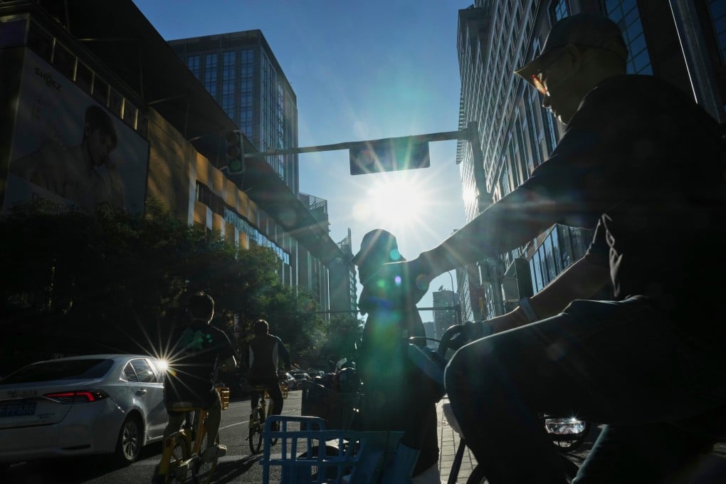 People ride bikes on a street in Beijing on August 29. The IMF projects that population ageing can cause China’s pension spending to rise by nearly 10 percentage points of GDP between 2024 and 2050. Photo: AP