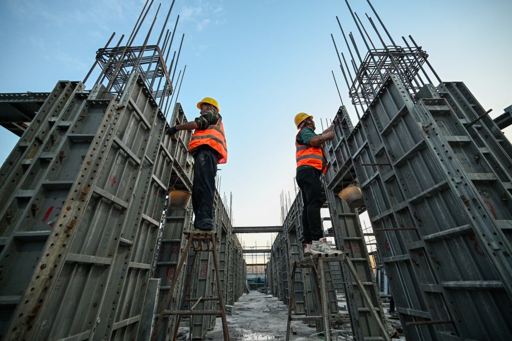 Workers at a train station construction site for a train station in Nanjing, Jiangsu province, on Wednesday. Photo: Getty Images