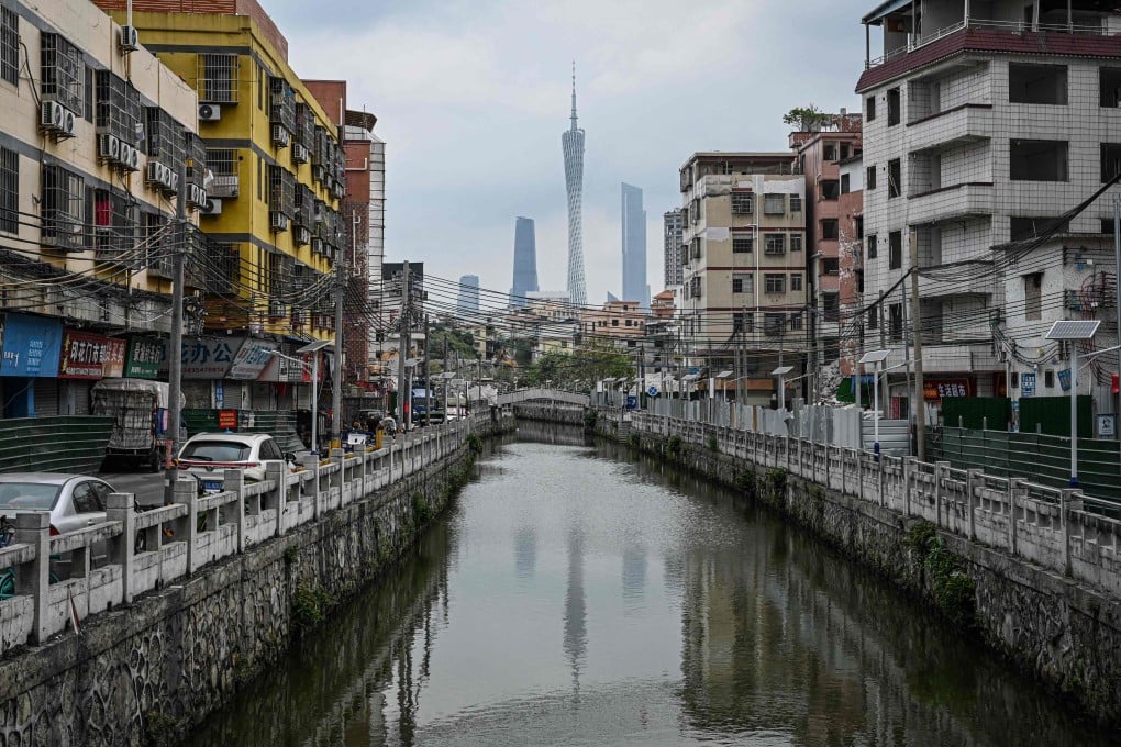 The city skyline rises over a canal in an urban village in Guangzhou, in southern China’s Guangdong province, on April 16. Photo: AFP