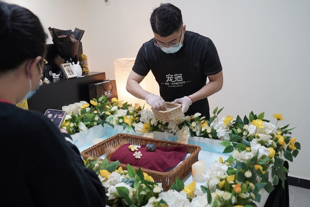 A pet funeral director in Wuhan, China, prepares a memorial service. The niche industry is experiencing rapid expansion despite minimal government oversight. Photo: Xinhua