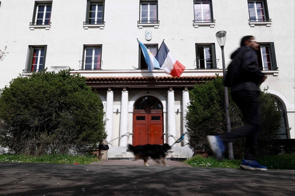 A person runs past Argentina House at Cite U in Paris in March. Residents have spoken out against evictions, far-right meetings and the management of the Argentine student residence by a new director with links to ultra-conservative circles. Photo: AFP
