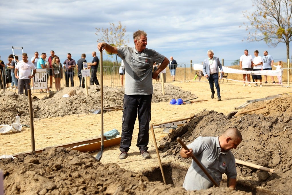 Gravediggers during as international gravedigging championship in Nyergesujfalu, Hungary on Saturday. Photo: Reuters