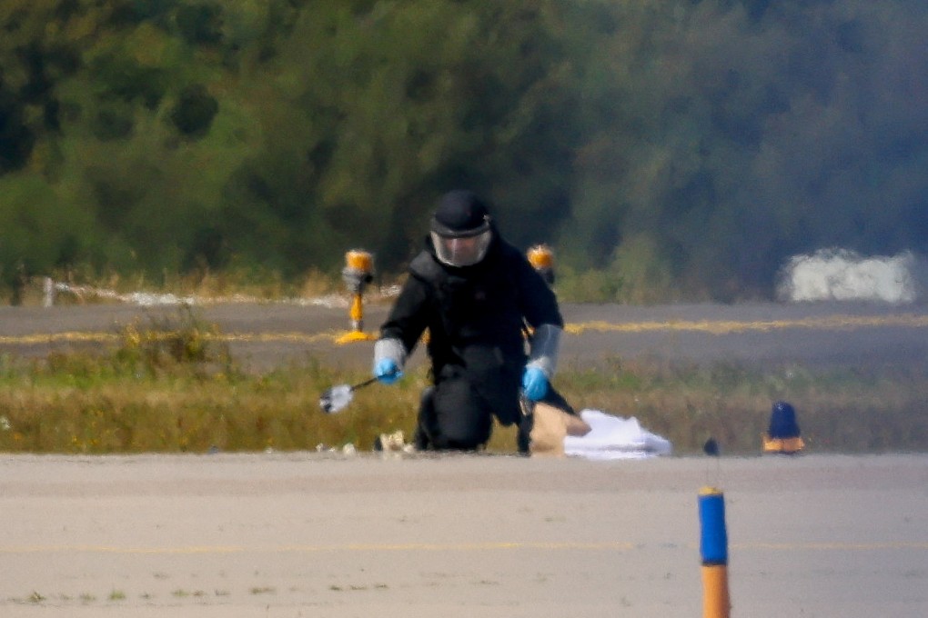 A police officer in protective clothing works at Leipzig/Halle Airport in Schkeuditz, Germany on August 5 after the police said explosives experts examined a drone near a runway. Photo: Reuters