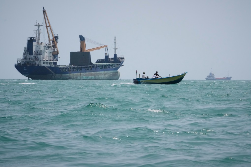 A motorboat passes a general cargo ship anchored in the Strait of Hormuz off Bandar Abbas, Iran on Sunday. Photo: AP