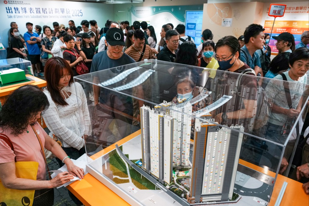 Residents hoping to take part in the city’s subsidised housing scheme view a model of an estate. Photo: Dickson Lee