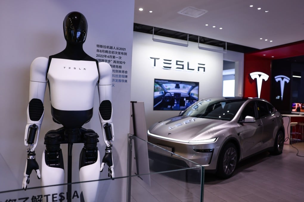 A Tesla humanoid robot and a Model Y electric vehicle are displayed in a store in Beijing in August. Photo: EPA