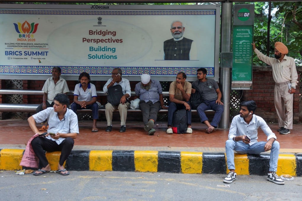 Passengers wait at a bus stop with a signboard featuring India’s Prime Minister Narendra Modi in New Delhi on September 3, ahead of the Brics summit this weekend. Photo: Reuters