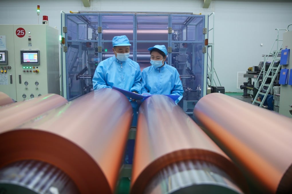 Employees work on a production line for lithium-ion battery copper foil at a workshop in China’s Henan province. Photo: Getty Images