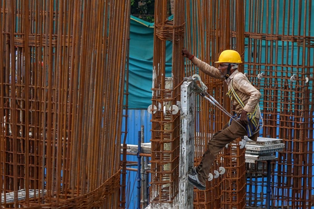 An Indian labourer works at a construction site in Mumbai on August 18. As a leading developer of green energy and high-speed rail around the world, there is no better partner for India to upgrade its infrastructure than China. Photo: EPA