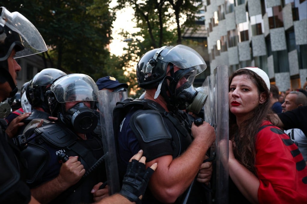 Police block a protester during a demonstration in Tirana, Albania, on Tuesday. Photo: Reuters
