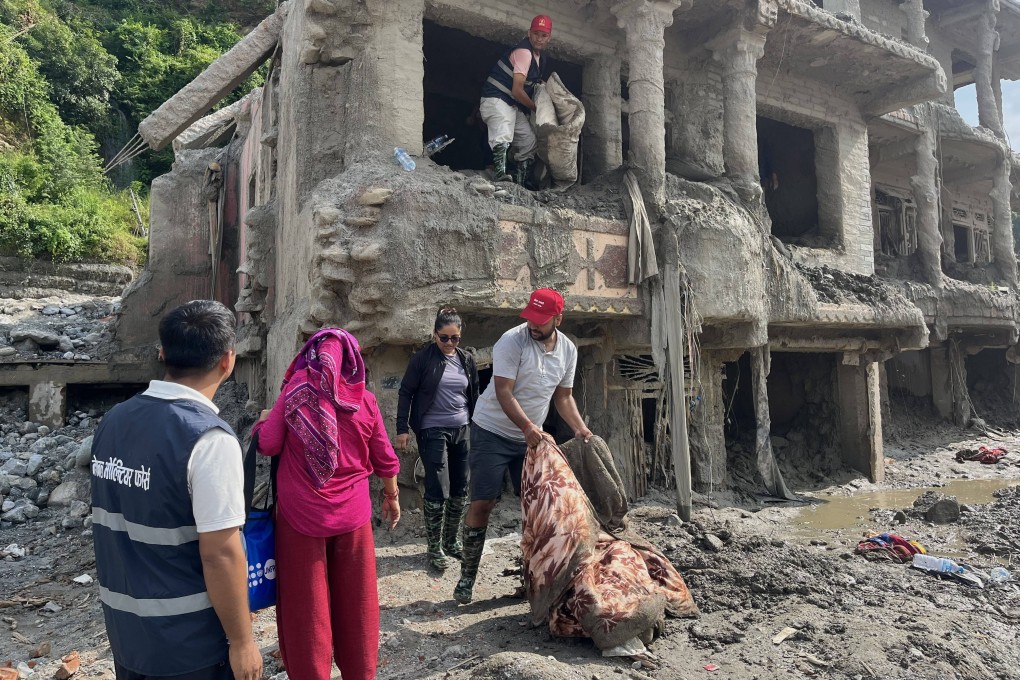 People cleaning up flood-ravaged houses in Dhunge Bazaar, Nuwakot, Nepal. Photo: Bibek Bhandari