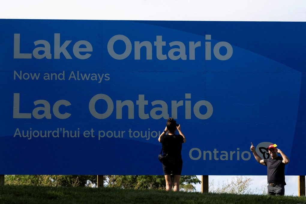 People take photos in front of a sign reading “Lake Ontario Now and Always” on August 29, 2026. The sign was unveiled by Ontario Premier Doug Ford at Fifty Point Conservation Area in the Canadian city of Hamilton after US President Donald Trump signed an executive order renaming the lake as Lake America. Photo: Reuters