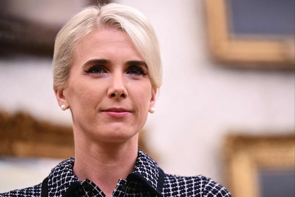 Natalie Harp, special assistant to US President Donald Trump, listens as he speaks in the Oval Office on Friday. Photo: AFP