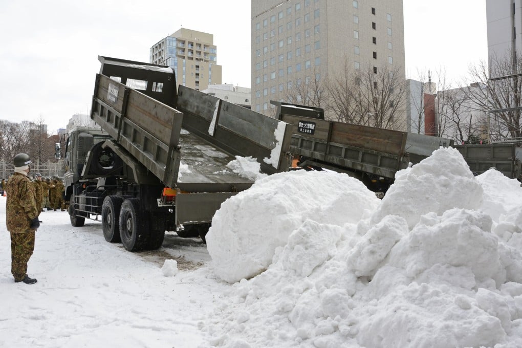 Snow is carried to Odori Park in Hokkaido, northern Japan, in January 2020, to create snow and ice sculptures for the Sapporo Snow Festival. Photo: Kyodo