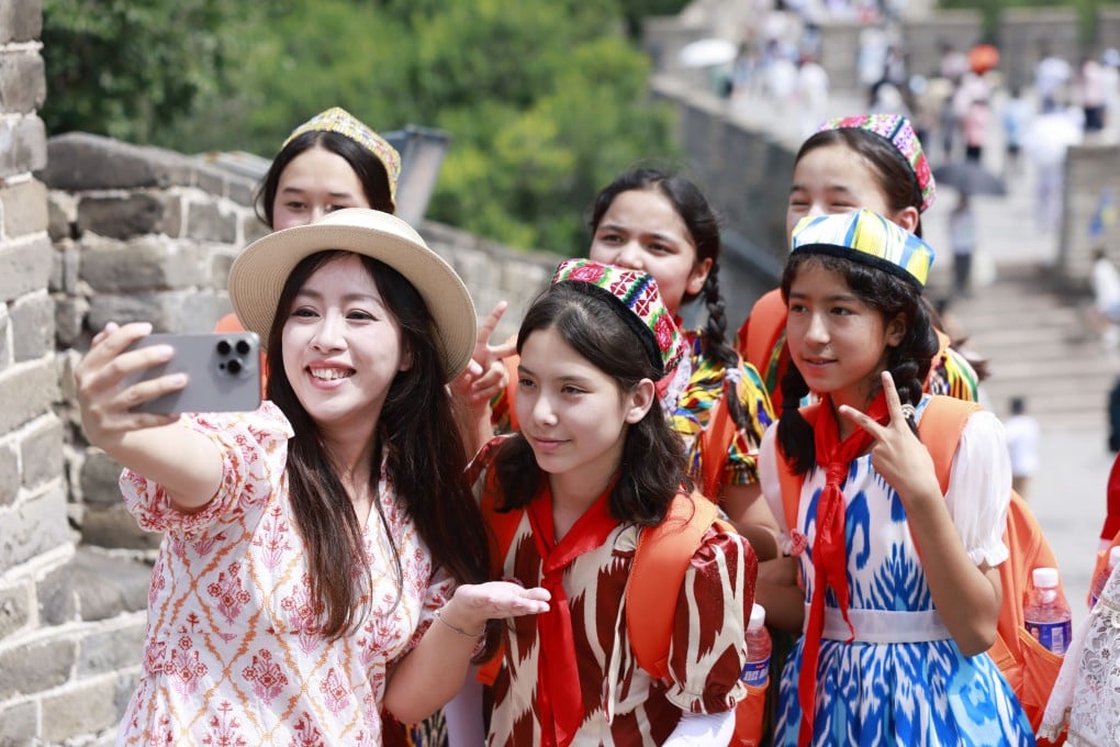 Students attending a summer camp pose for a selfie at the Badaling section of the Great Wall in Beijing in July. Photo: Xinhua)