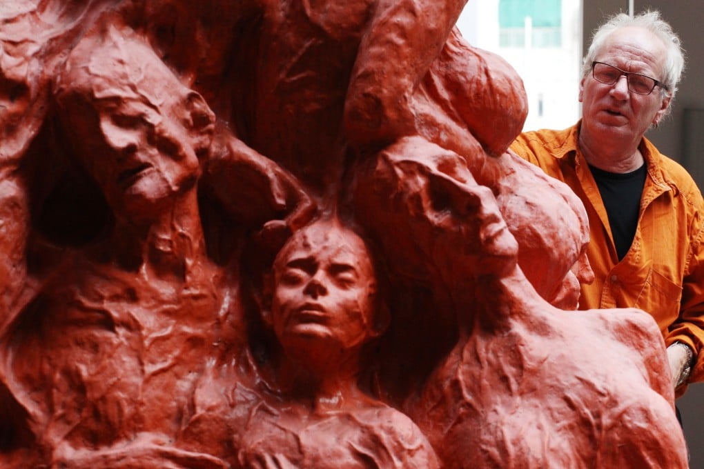 Danish sculptor Jens Galschiot stands beside the “Pillar of Shame” at the University of Hong Kong in 2013. Photo: Handout