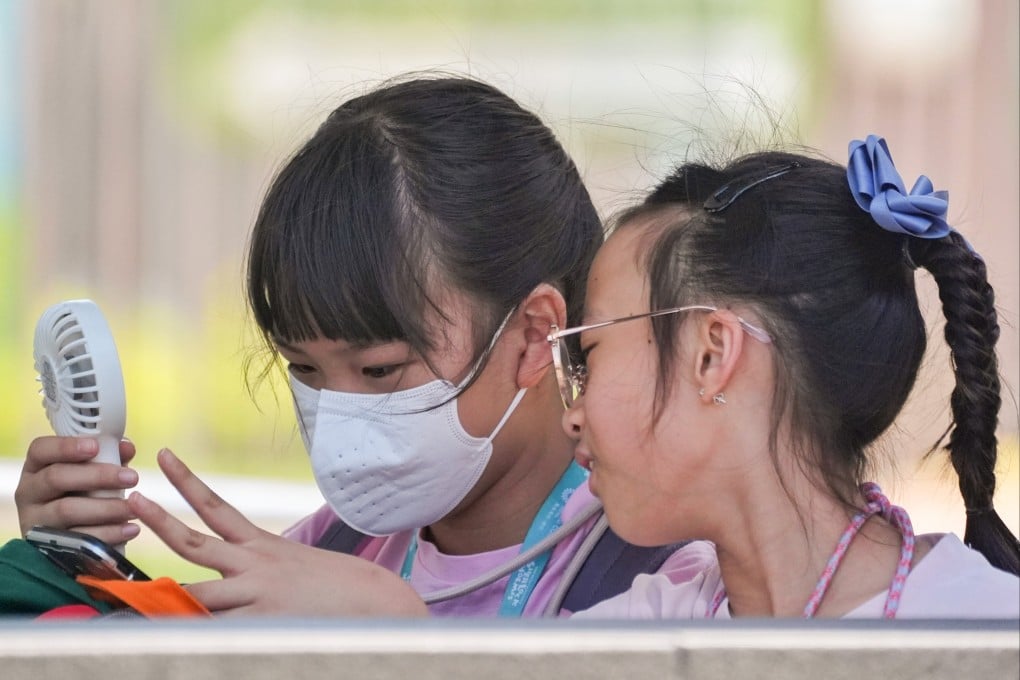A child wears a face mask outdoors on Friday amid Hong Kong’s summer flu season. Photo: Elson Li