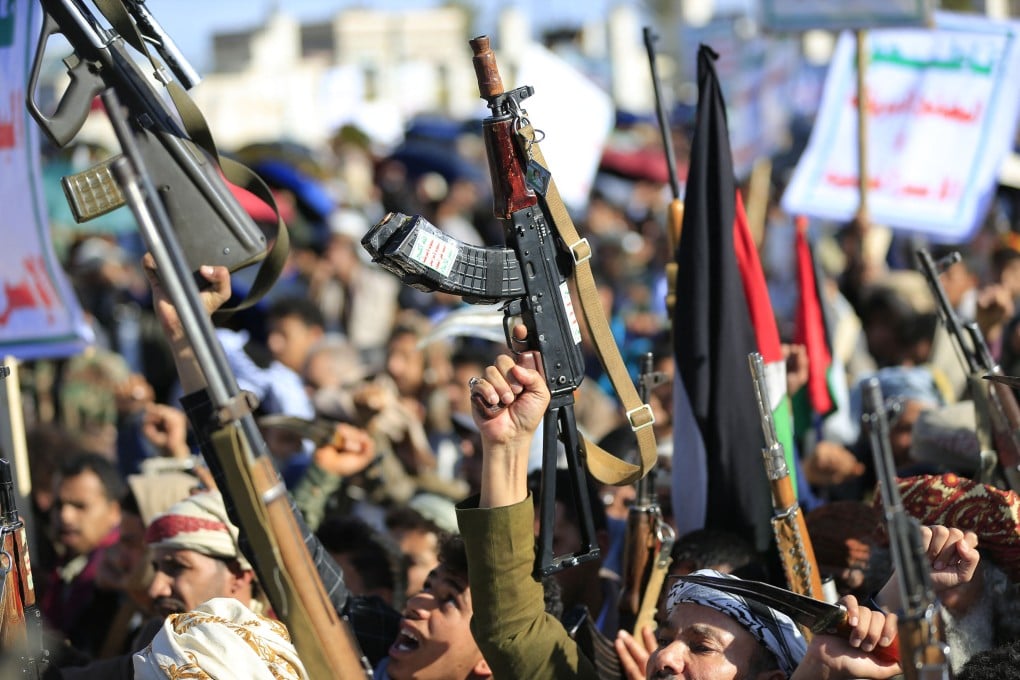 Houthis brandish their weapons as they rally in the Yemeni capital of Sanaa in March. Photo: TNS