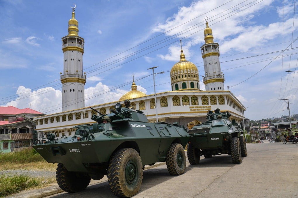 Army personnel aboard armoured vehicles patrol past the Grand Mosque in Marawi, Lanao del sur province on the southern Philippine island of Mindanao. Photo: AFP