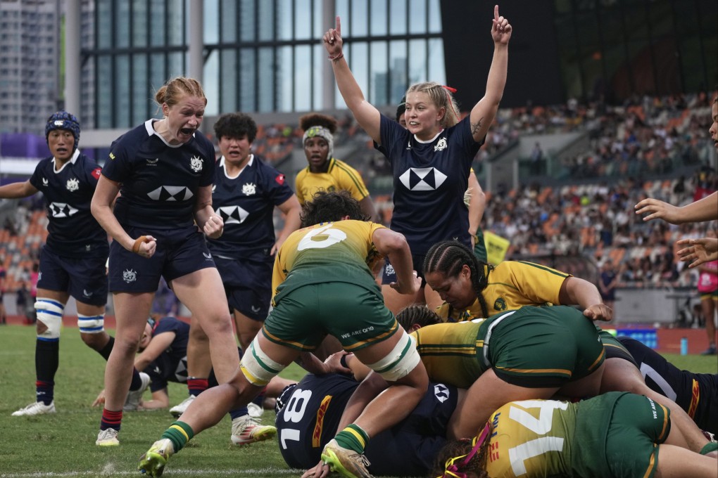 Hong Kong (in blue) celebrate a try against Brazil in their WXV Global Series Challenger match at Kai Tak Youth Sports Ground on Sunday. Photo: Karma Lo