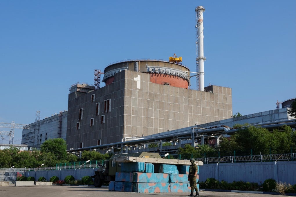 A Russian service member stands guard at a checkpoint near the Zaporizhzhia nuclear power plant. Photo: Reuters