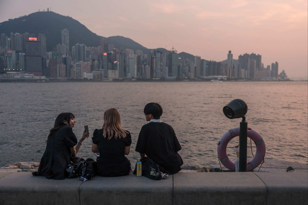 People sit on a promenade next to Victoria Harbour in Hong Kong on September 8. The city is uniquely positioned to support the national effort to construct alternative financial and technological ecosystems. Photo: AFP