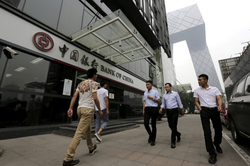 Pedestrians walk past a branch of Bank of China in Beijing. Photo: Reuters